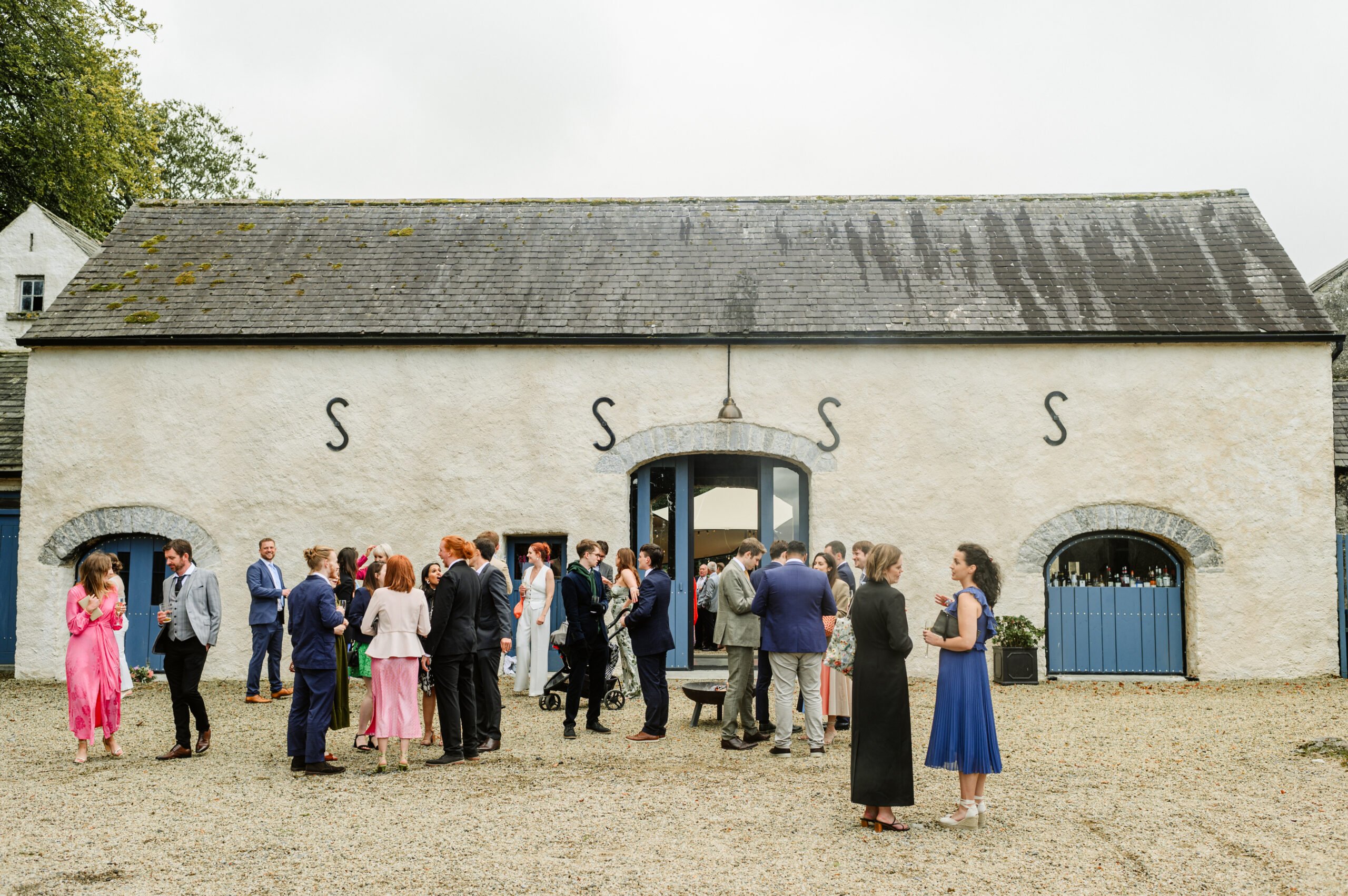 wedding guest celebrating at courtyard in juniper barn venue