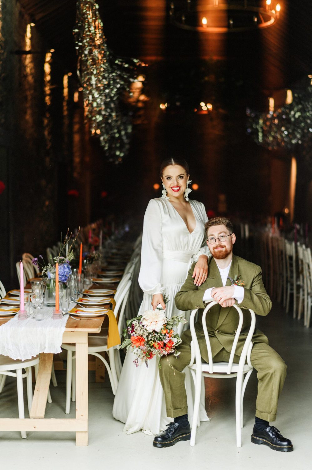 Bride and groom posing at their wedding reception in Juniper Barn, Sligo, with rustic d&eacute;cor.