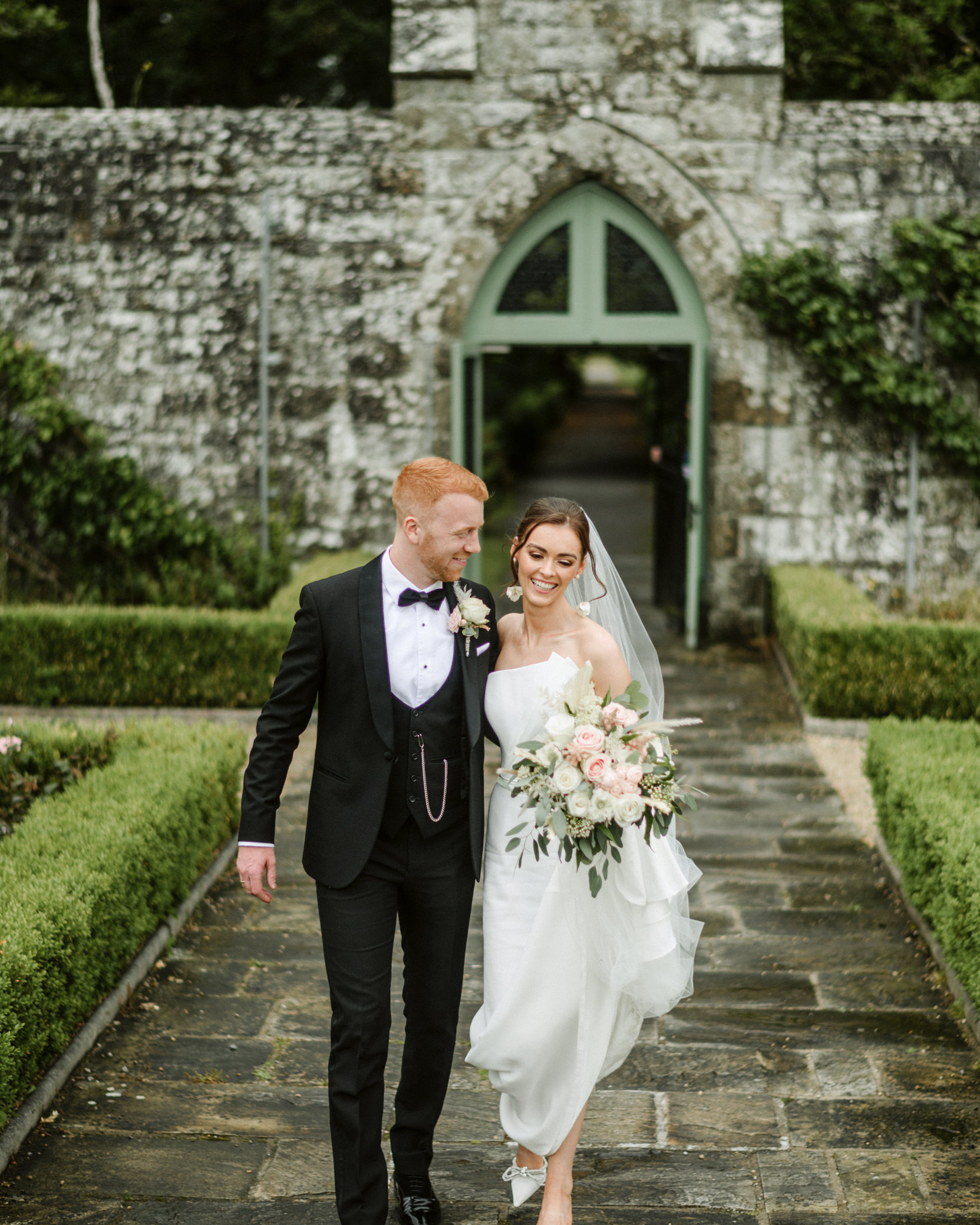 bride and groom at entrance to walled garden in Lough Rynn castle waled garden